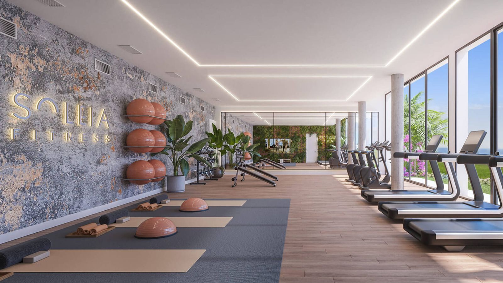 Moderne sportschool in Soleia Living met loopbanden en fitnessapparatuur.